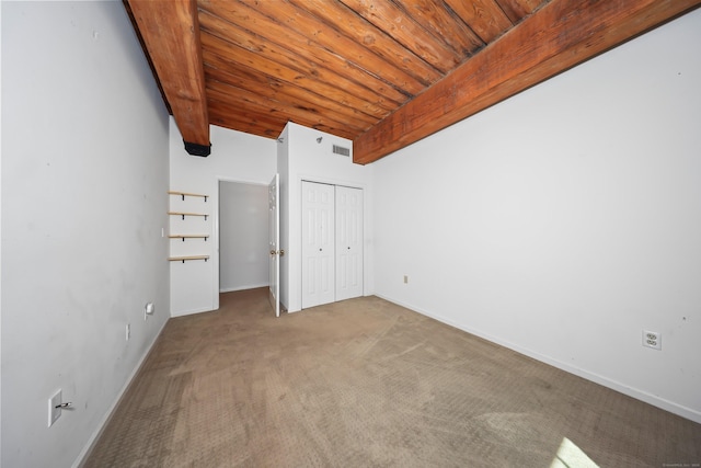 unfurnished bedroom featuring wood ceiling, visible vents, carpet floors, baseboards, and a closet