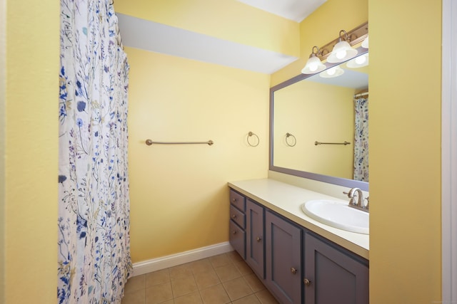bathroom featuring vanity, tile patterned flooring, baseboards, and a shower with shower curtain