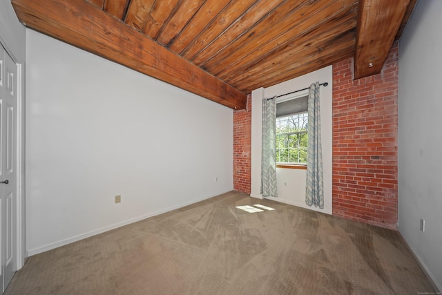 unfurnished room featuring wood ceiling, baseboards, and carpet