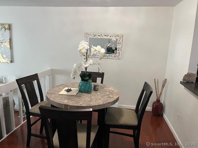 57 Meetinghouse Vlg Unit 6, Meriden, CT 06450 - dining room with baseboards and wood finished floors