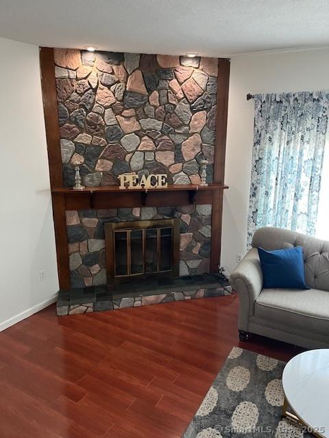 57 Meetinghouse Vlg Unit 6, Meriden, CT 06450 - living room featuring a fireplace and wood finished floors