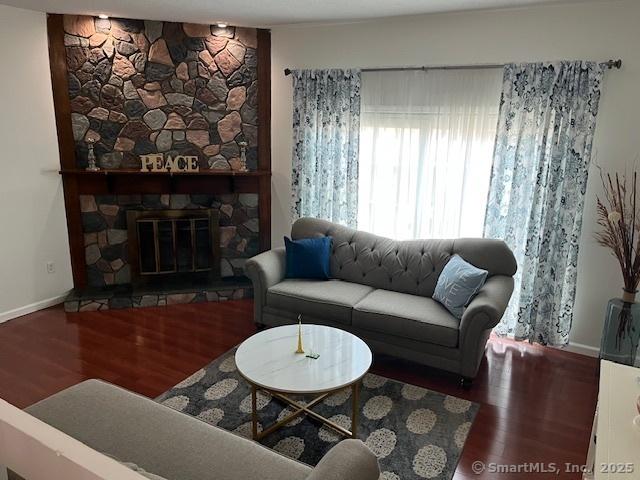 57 Meetinghouse Vlg Unit 6, Meriden, CT 06450 - living area featuring baseboards, wood finished floors, and a fireplace