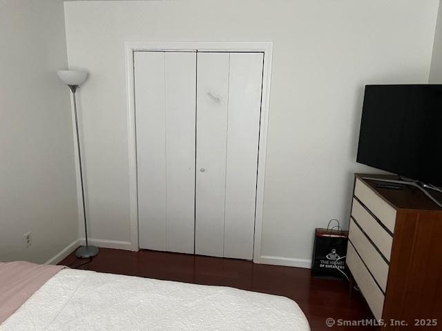 57 Meetinghouse Vlg Unit 6, Meriden, CT 06450 - bedroom featuring baseboards, wood finished floors, and a closet