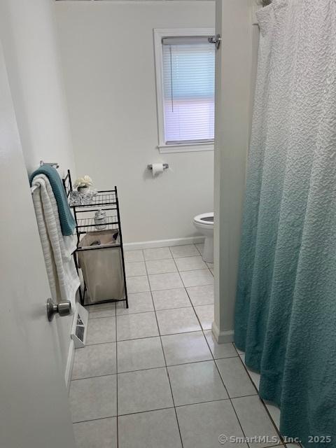 57 Meetinghouse Vlg Unit 6, Meriden, CT 06450 - full bathroom with baseboards, tile patterned floors, toilet, and curtained shower