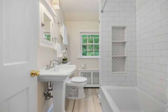 6 Weathervane Hl, Westport, CT 06880 - bathroom featuring radiator heating unit, toilet, wood finished floors, and washtub / shower combination