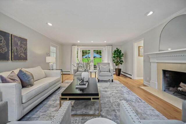 6 Weathervane Hl, Westport, CT 06880 - living area featuring baseboard heating, a fireplace with flush hearth, wood finished floors, french doors, and recessed lighting