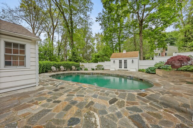 6 Weathervane Hl, Westport, CT 06880 - view of swimming pool featuring french doors, a patio area, an outdoor structure, and a fenced backyard