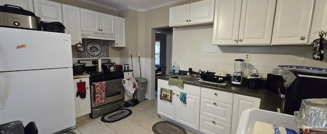324 Mountain Grove St, Bridgeport, CT 06605 - kitchen with crown molding, stainless steel gas range, freestanding refrigerator, under cabinet range hood, and white cabinetry
