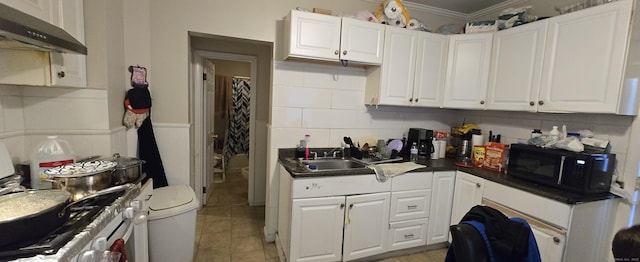 324 Mountain Grove St, Bridgeport, CT 06605 - kitchen featuring black microwave, dark countertops, a sink, ornamental molding, and under cabinet range hood
