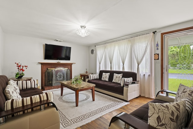 201 Orchard Ave, Newington, CT 06111 - living area with a fireplace, a chandelier, and wood finished floors
