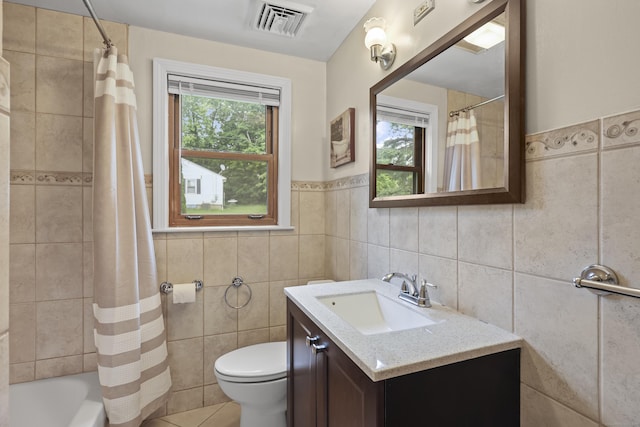 201 Orchard Ave, Newington, CT 06111 - full bath with tile walls, vanity, shower / tub combo with curtain, tile patterned floors, and wainscoting