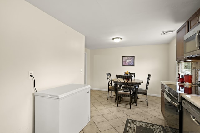 201 Orchard Ave, Newington, CT 06111 - dining area featuring light tile patterned floors and baseboards