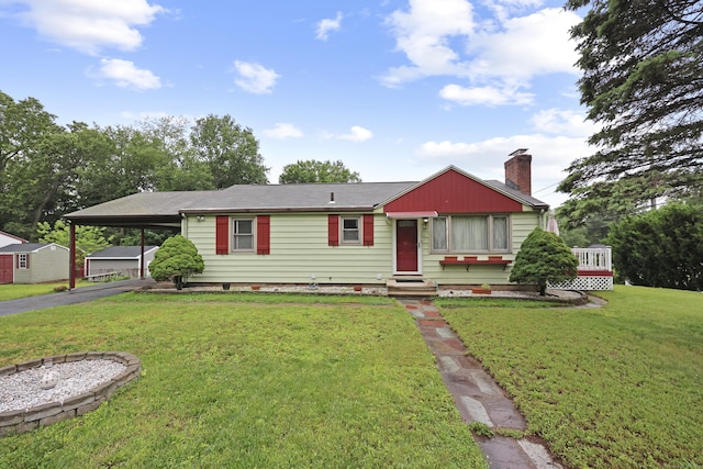 201 Orchard Ave, Newington, CT 06111 - view of front facade featuring a chimney, entry steps, an attached carport, a front yard, and driveway
