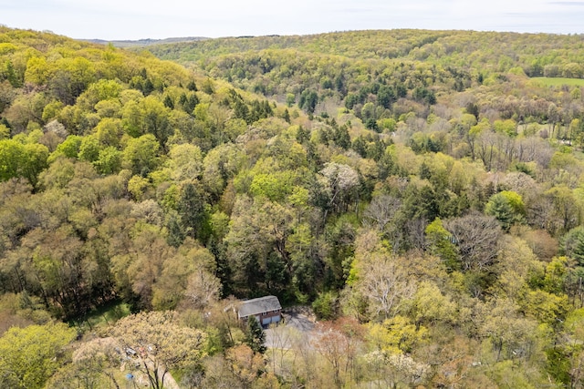 drone / aerial view featuring a forest view
