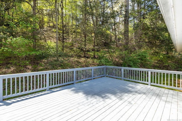 wooden deck featuring a wooded view