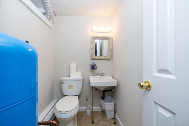 half bath featuring toilet, baseboards, tile patterned flooring, and a baseboard radiator