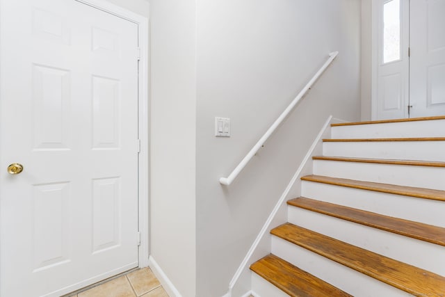 staircase with tile patterned floors and baseboards