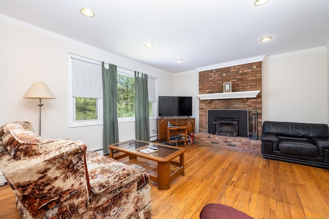 living room with ornamental molding, baseboard heating, recessed lighting, and wood finished floors