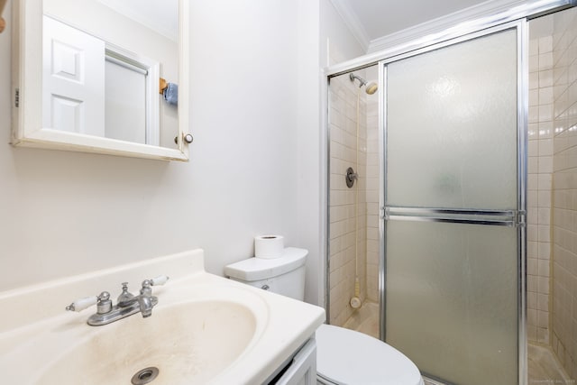 full bathroom featuring vanity, toilet, ornamental molding, and a stall shower
