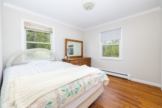 bedroom with a baseboard heating unit, ornamental molding, wood finished floors, and multiple windows