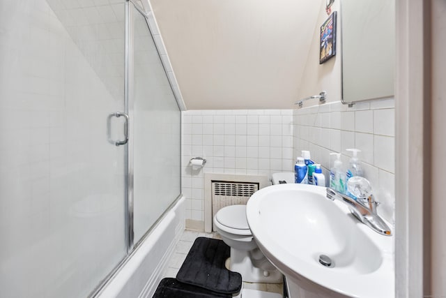 19 Terhune Ave, Branford, CT 06405 - bathroom with tile walls, toilet, radiator heating unit, a sink, and combined bath / shower with glass door