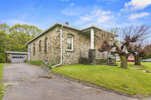298 Wall St, Waterbury, CT 06704 - view of property exterior with stone siding, a chimney, a lawn, an outbuilding, and asphalt driveway