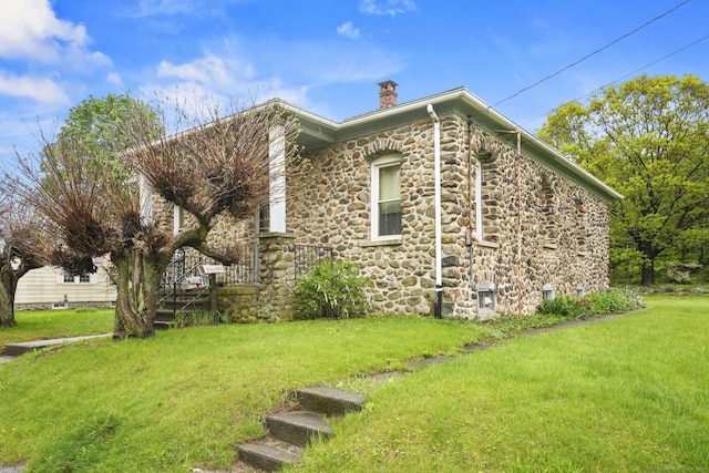 298 Wall St, Waterbury, CT 06704 - view of side of home with stone siding, a chimney, and a lawn