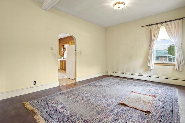 298 Wall St, Waterbury, CT 06704 - spare room featuring arched walkways, baseboard heating, wood finished floors, beam ceiling, and baseboards
