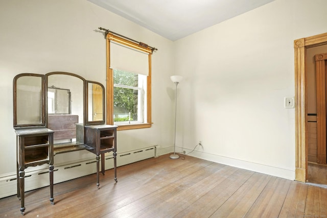 298 Wall St, Waterbury, CT 06704 - bedroom featuring a baseboard radiator, wood-type flooring, and baseboards
