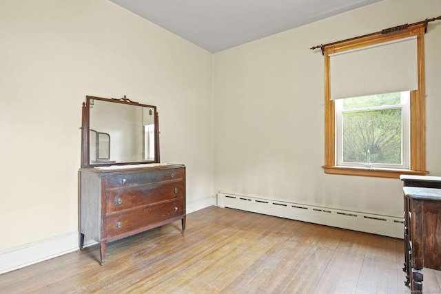 298 Wall St, Waterbury, CT 06704 - unfurnished room with baseboard heating, hardwood / wood-style flooring, and baseboards
