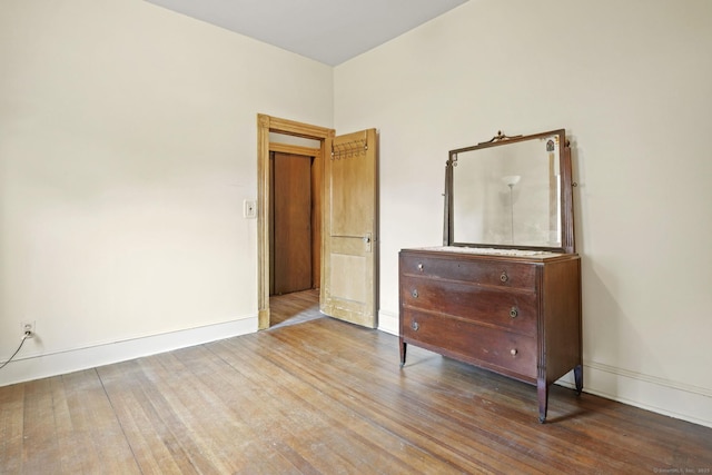 298 Wall St, Waterbury, CT 06704 - unfurnished bedroom with wood finished floors and baseboards