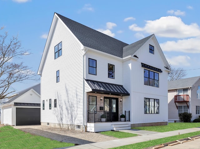 13 Dunbar Rd, Milford, CT 06460 - modern farmhouse style home featuring a detached garage, a standing seam roof, a shingled roof, and an outdoor structure