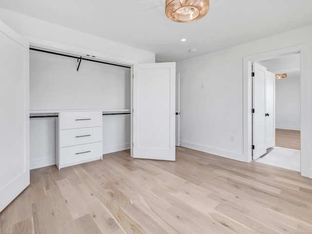 13 Dunbar Rd, Milford, CT 06460 - unfurnished bedroom with baseboards, a closet, and light wood-style flooring