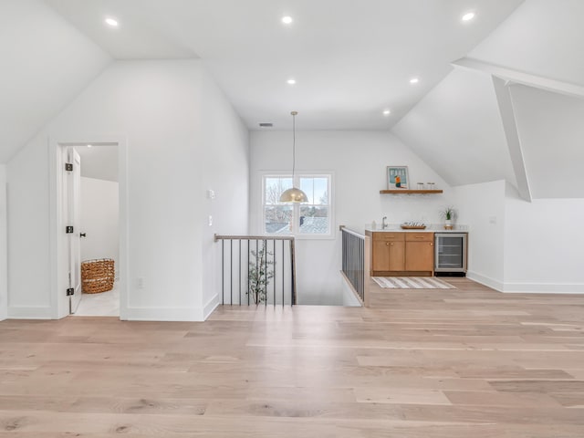 13 Dunbar Rd, Milford, CT 06460 - bonus room with a dry bar, light wood-style floors, beverage cooler, baseboards, and vaulted ceiling