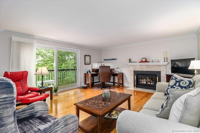 28D Harbour Vlg, Branford, CT 06405 - living room featuring wood finished floors, a tile fireplace, and crown molding