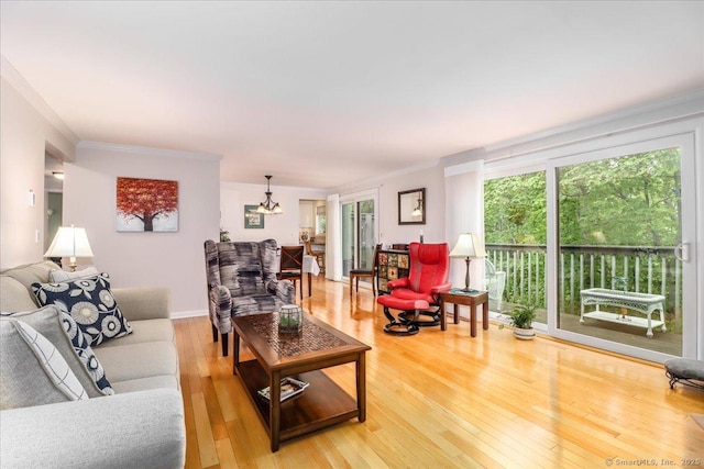 28D Harbour Vlg, Branford, CT 06405 - living room with crown molding, a chandelier, and light wood-style floors