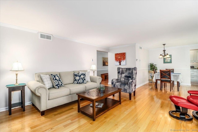 28D Harbour Vlg, Branford, CT 06405 - living room with a chandelier, light wood-style floors, ornamental molding, and baseboards