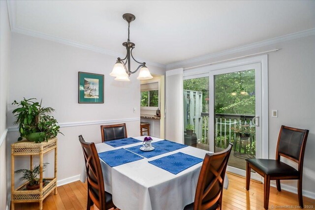 28D Harbour Vlg, Branford, CT 06405 - dining room featuring light wood-style floors, crown molding, a chandelier, and baseboards