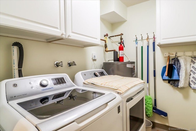 28D Harbour Vlg, Branford, CT 06405 - laundry area with washer and dryer, water heater, and cabinet space