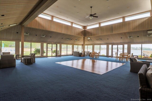 28D Harbour Vlg, Branford, CT 06405 - carpeted living area featuring ceiling fan, high vaulted ceiling, healthy amount of natural light, and a water view