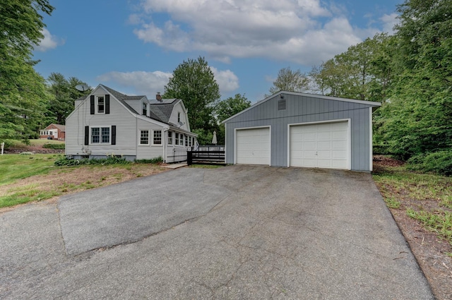 140 College Ave, Torrington, CT 06790 - view of home's exterior featuring an outbuilding, a garage, and a chimney