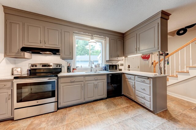 140 College Ave, Torrington, CT 06790 - kitchen featuring appliances with stainless steel finishes, gray cabinetry, under cabinet range hood, a sink, and a peninsula