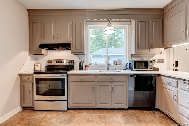140 College Ave, Torrington, CT 06790 - kitchen with stainless steel appliances, gray cabinetry, under cabinet range hood, a sink, and decorative backsplash