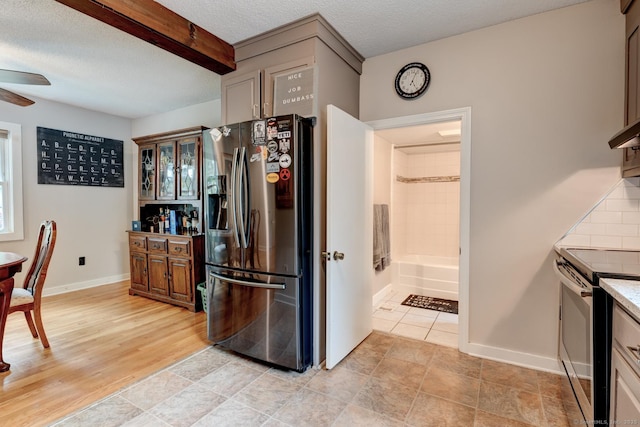 140 College Ave, Torrington, CT 06790 - kitchen featuring stainless steel appliances, ceiling fan, a textured ceiling, baseboards, and tasteful backsplash