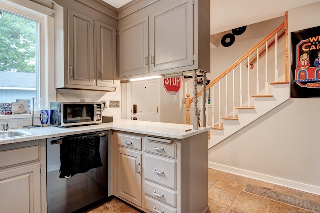 140 College Ave, Torrington, CT 06790 - kitchen featuring dishwasher, stainless steel microwave, a peninsula, tasteful backsplash, and light stone counters