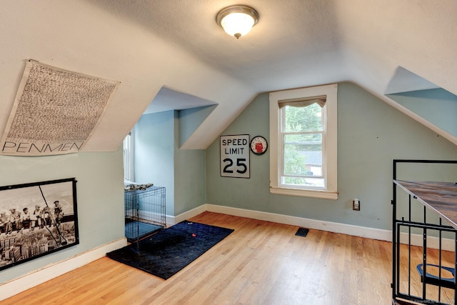 140 College Ave, Torrington, CT 06790 - bonus room featuring wood finished floors, baseboards, lofted ceiling, and a textured ceiling