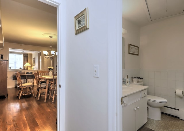 24 Wall St, Shelton, CT 06484 - bathroom featuring a baseboard heating unit, toilet, vanity, wood finished floors, and tile walls