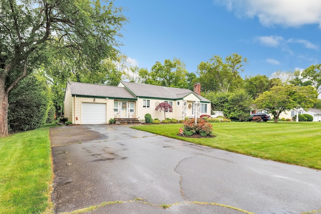 319 Wheeler Park Ave, Fairfield, CT 06825 - view of front of house with a garage, asphalt driveway, a front lawn, and a chimney