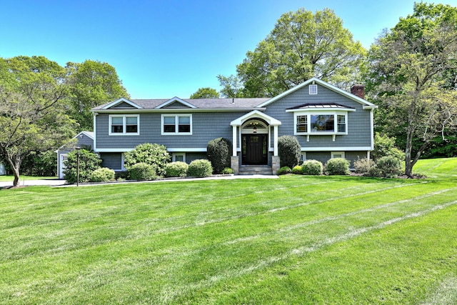 664 S Greenbrier Dr, Orange, CT 06477 - bi-level home with a chimney and a front yard