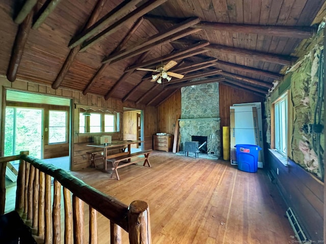 living room featuring wood ceiling, a fireplace, lofted ceiling with beams, wood walls, and hardwood / wood-style flooring